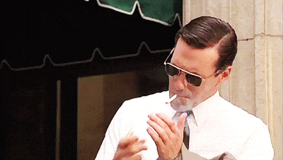 Don Draper lights a cigarette.